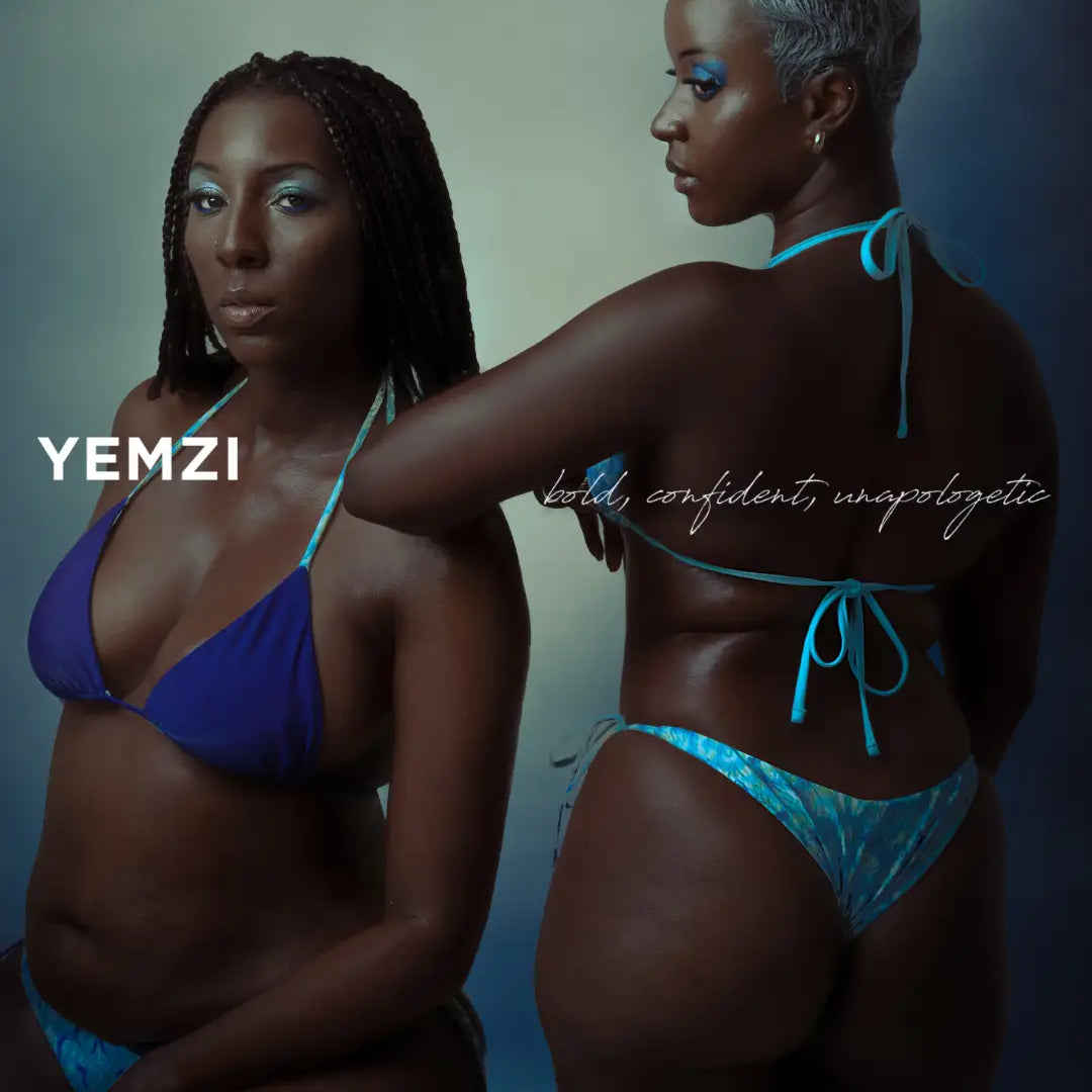 two black models wearing blue bikinis against an ombre backdrop