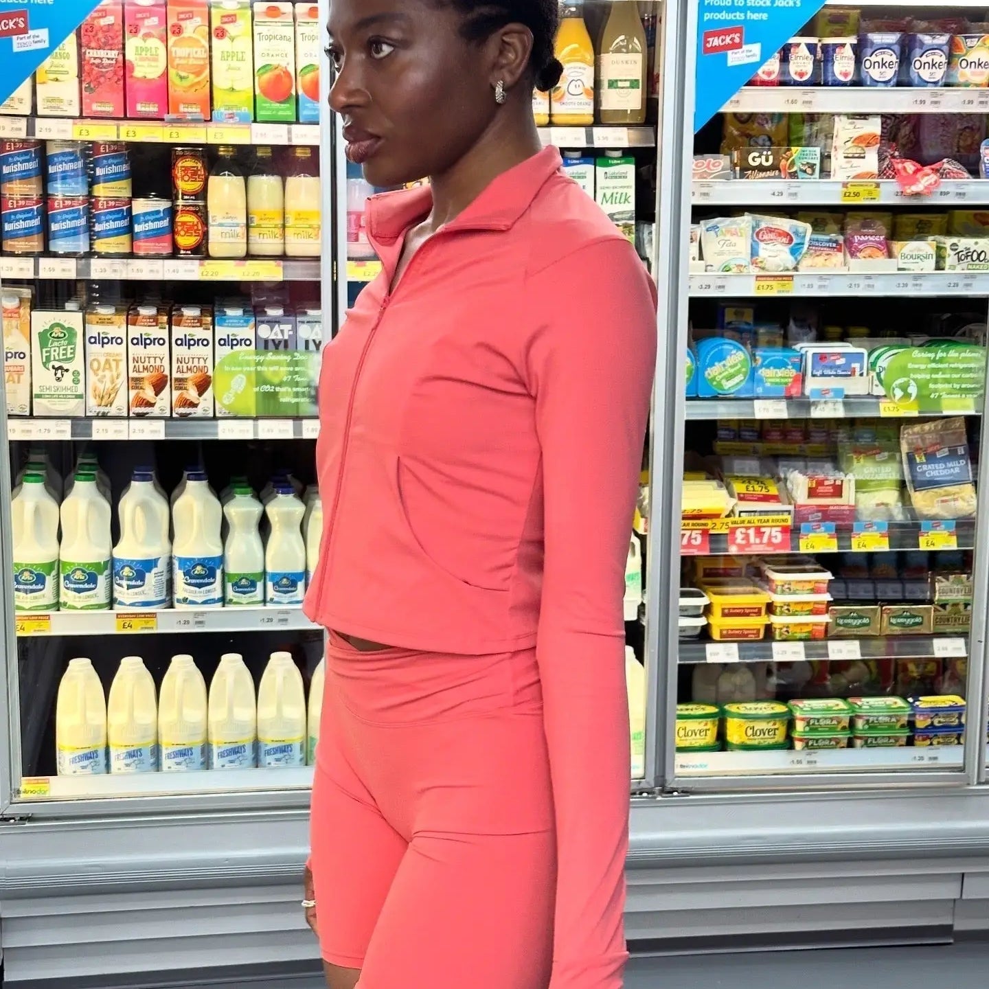 yem akingbade in guava activewear clothing set in a convenient store