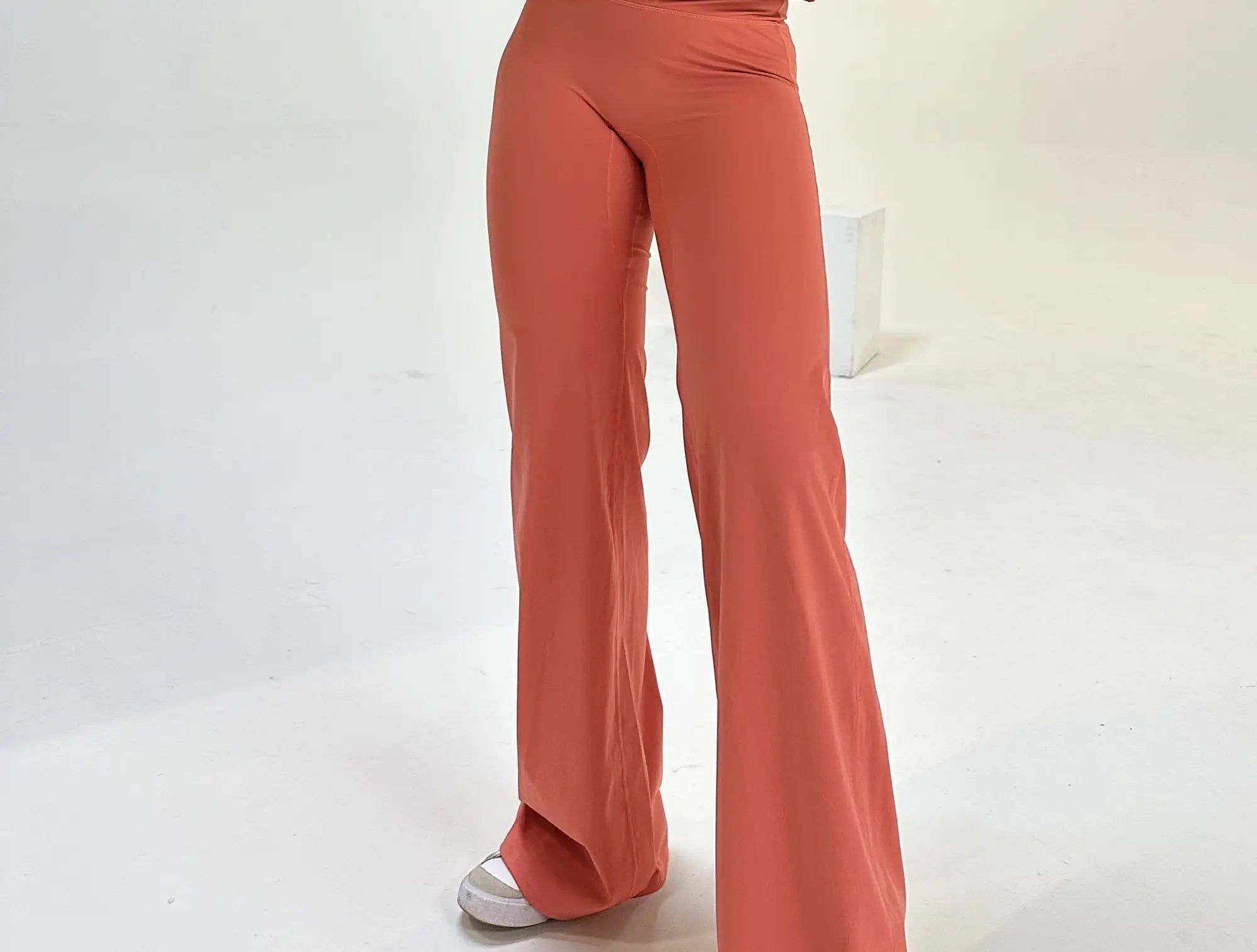 guava shade flare pants in a white studio 