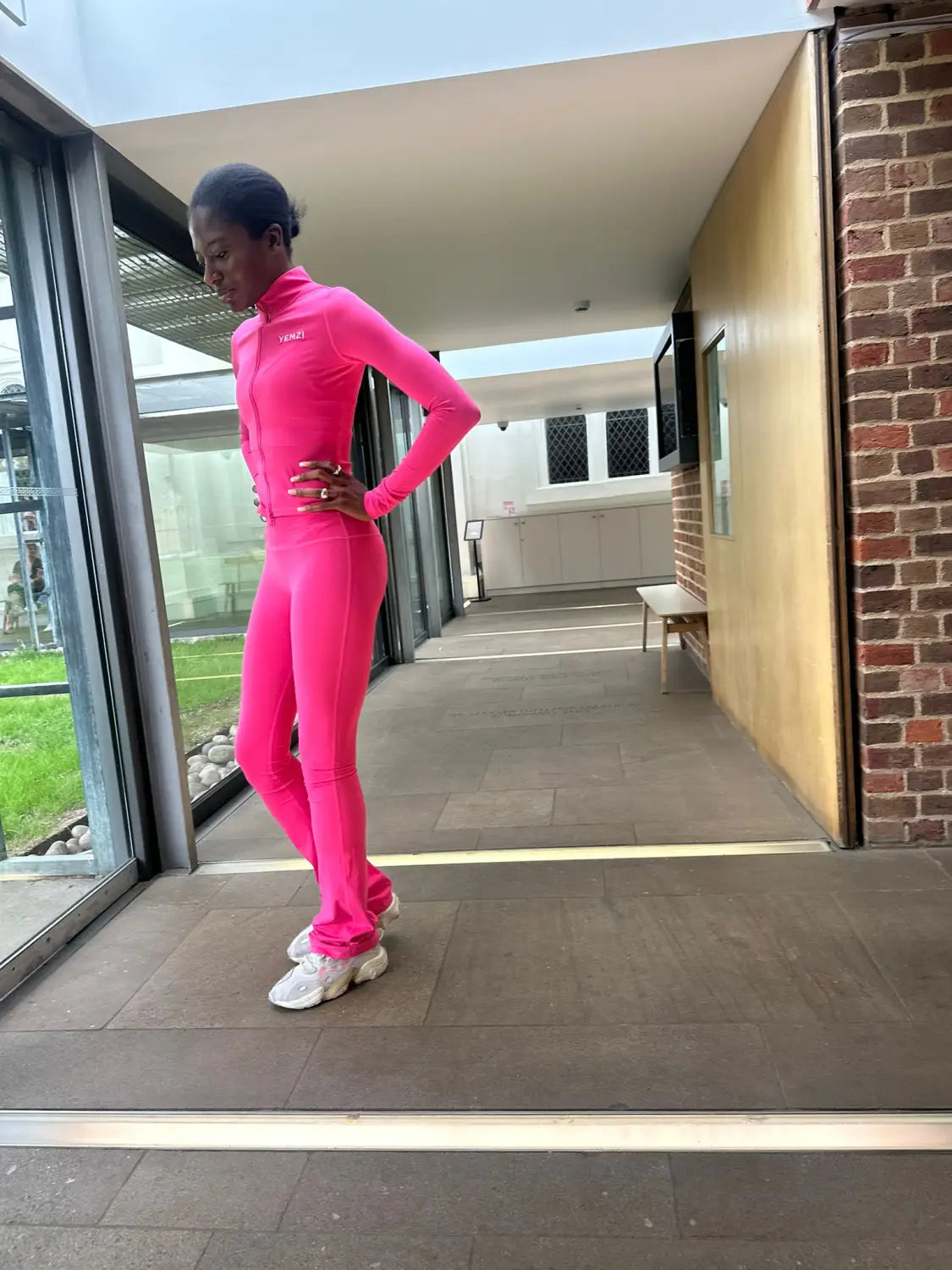 Yem Akingbade wearing a tall Yemzi pink activewear set