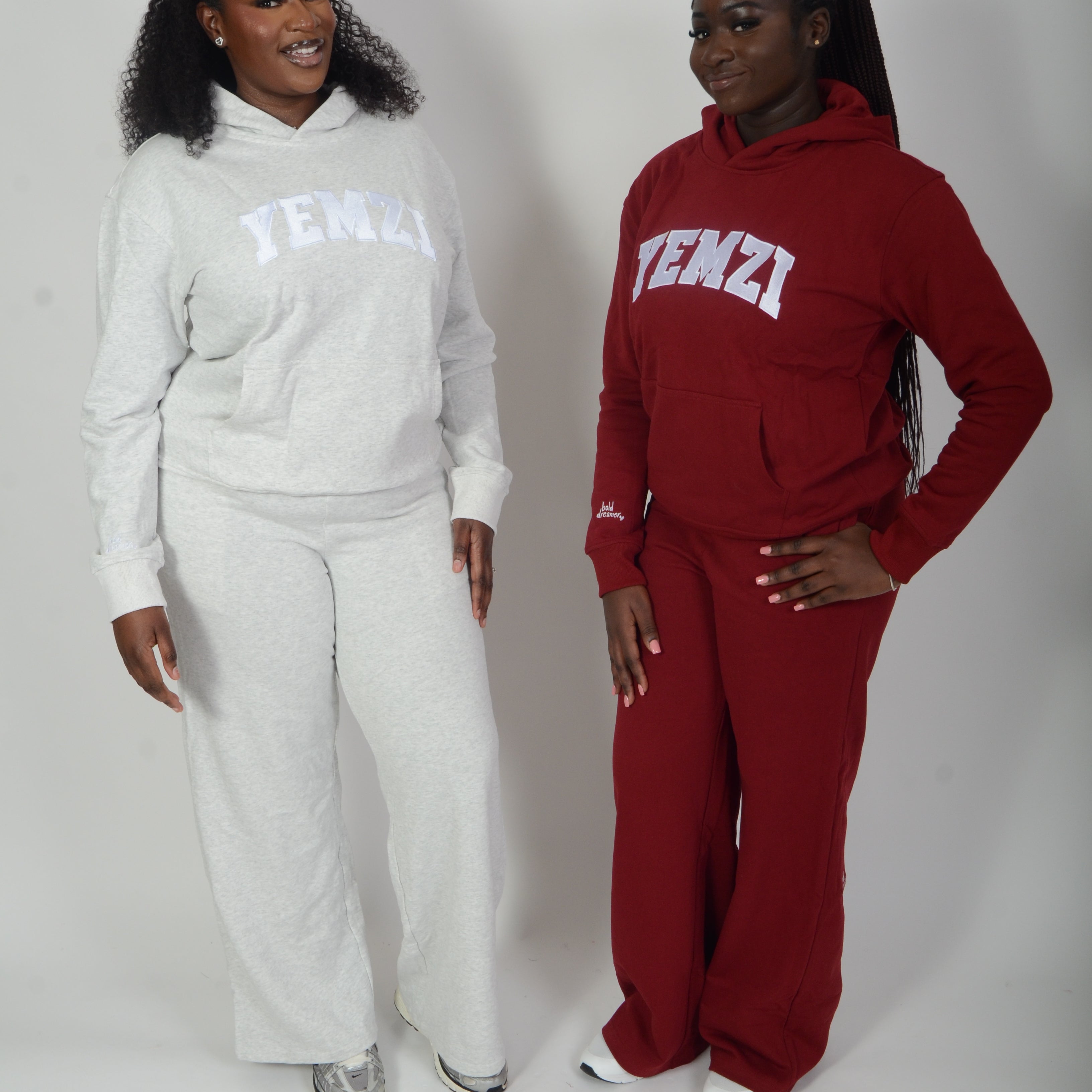 Two people wearing white and red tracksuits on a white background