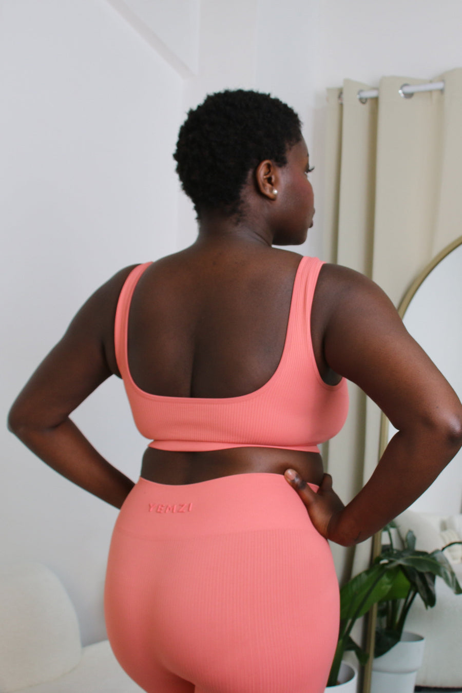 African model wearing the yemzi guava pink seamless ribbed bra and legging set 