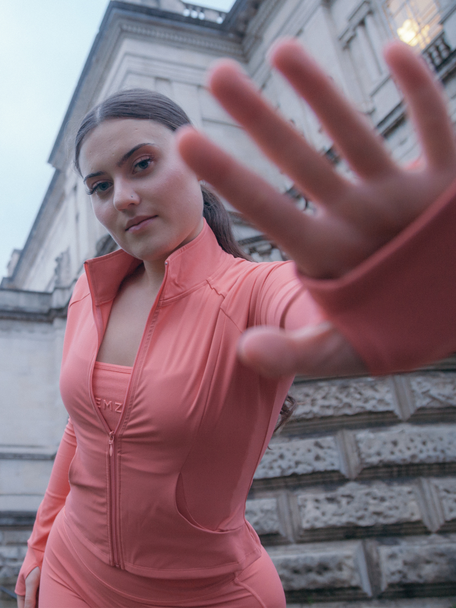 Yenzu guava pink zip jacket warn by model outside Tate gallery