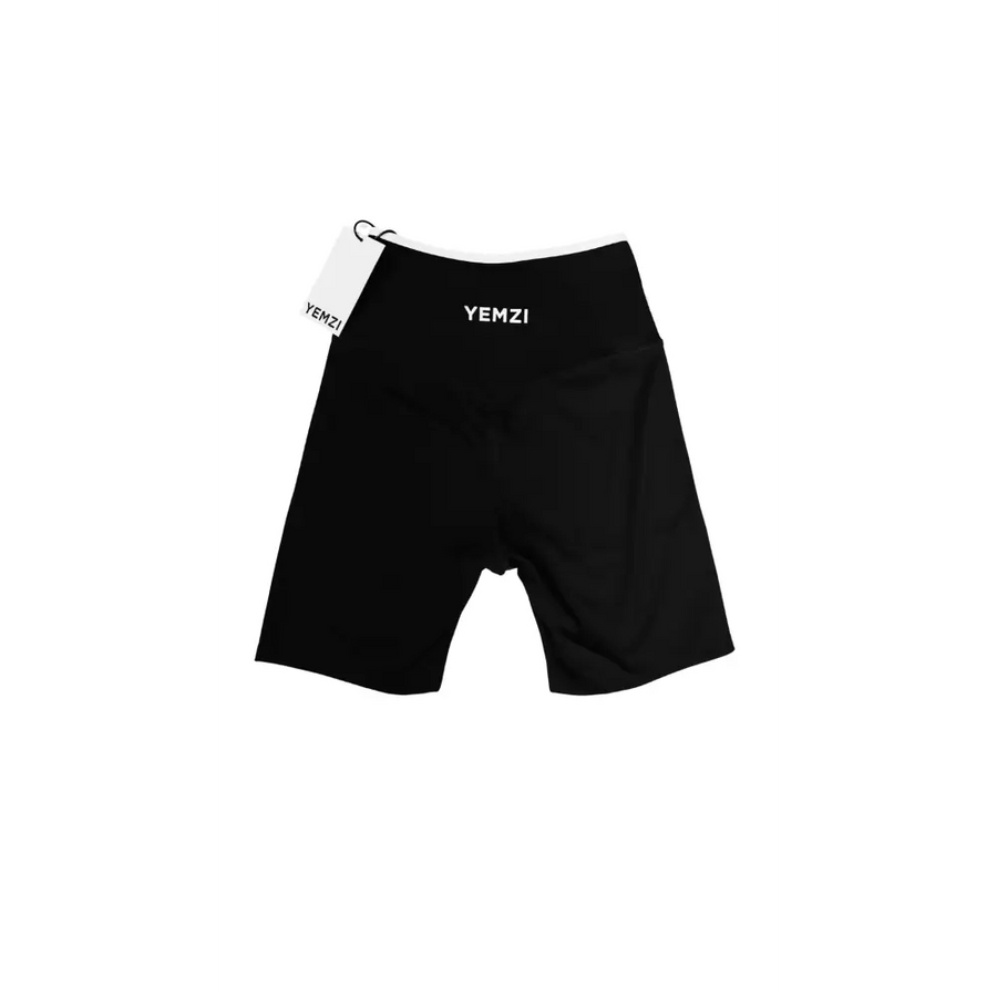 Black athletic shorts with YEMZI branding on a white background