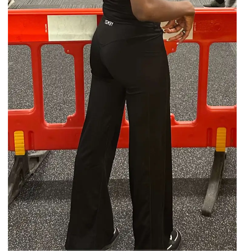 Tall contour black pants worn by a lady in the gym 