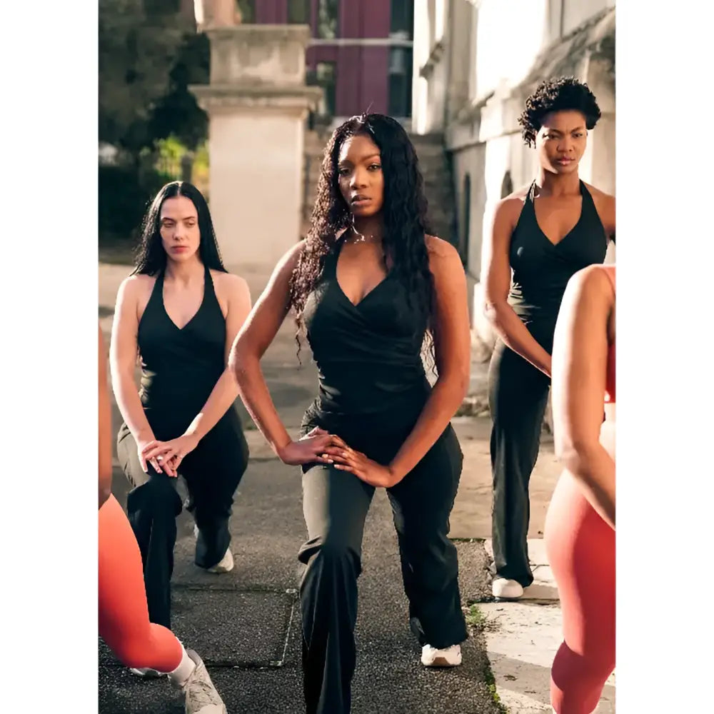 Group of women in athletic wear posing outdoors on a street.