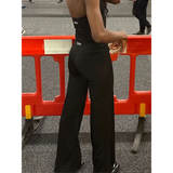 Tall contour black pants worn by a lady in the gym 