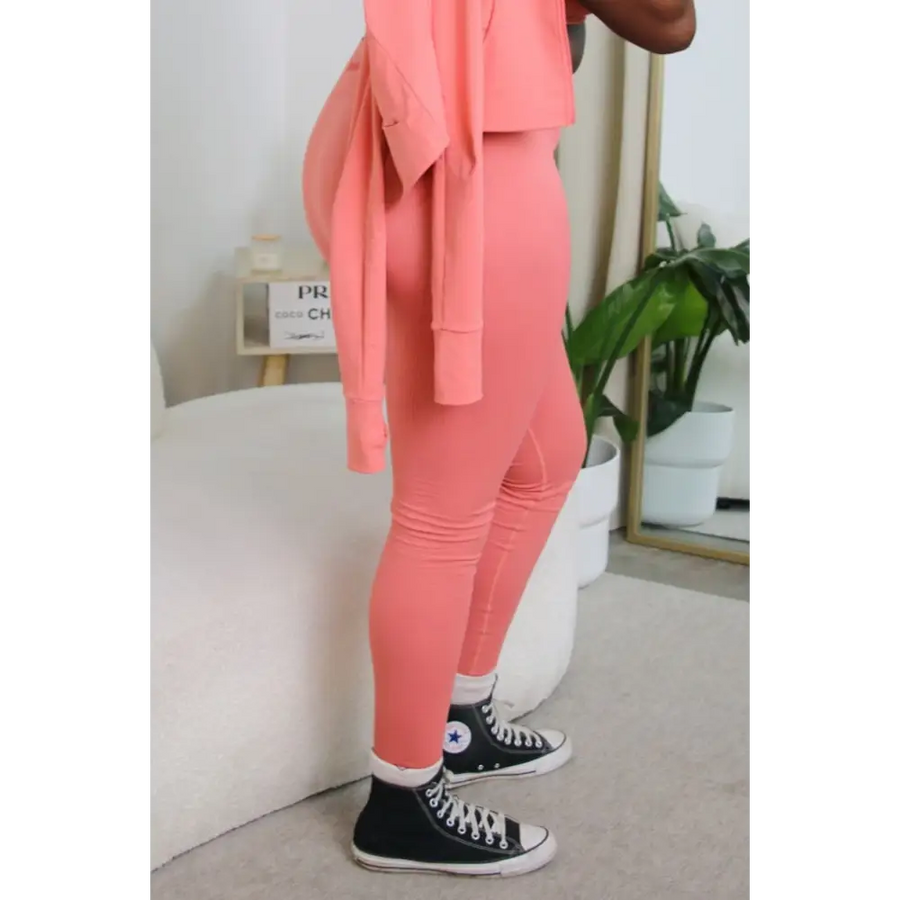 Model wearing size large Yemzi stretchy sculpting activewear leggings in Guava pink colour