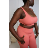 Model wearing size large Yemzi activewear set in Guava