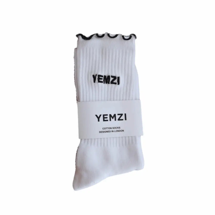 White socks with frill black trim and 'YEMZI' branding on a white background