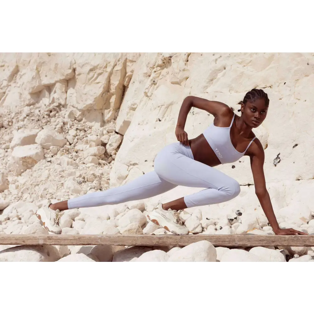 Black model wearing yemzi Pearl Lilac Smooth Bra in front of cliffs