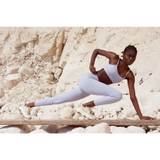 Black model wearing yemzi Pearl Lilac Smooth Bra in front of cliffs