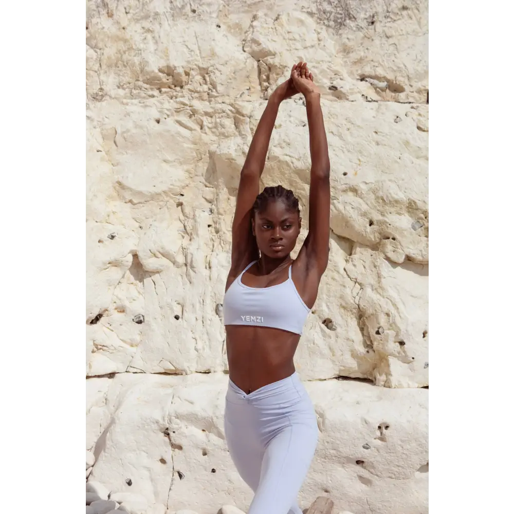 Model wearing Yemzi Lilac two piece set pearl activewear set in rocky outdoor location