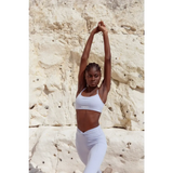 Model wearing Yemzi Lilac two piece set pearl activewear set in rocky outdoor location