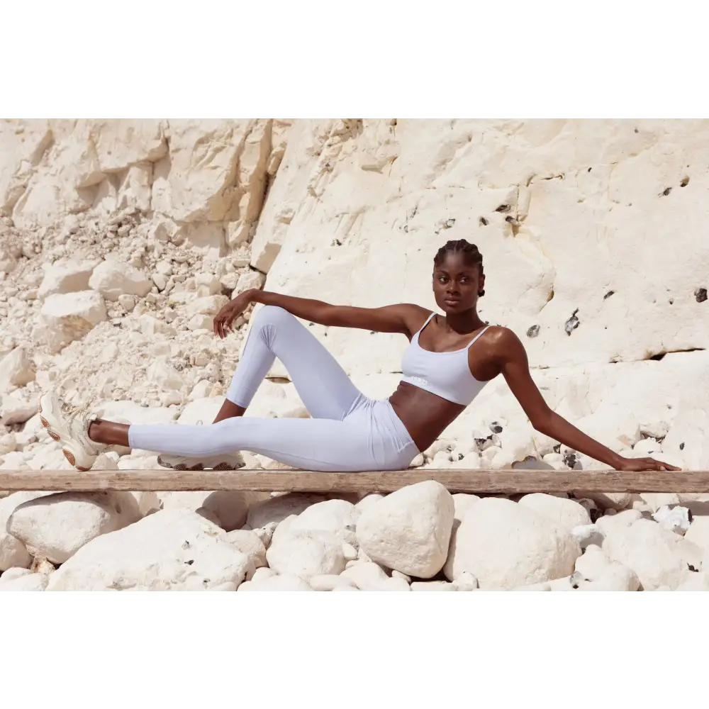 Model wearing Yemzi Lilac two piece set pearl activewear set in rocky outdoor location