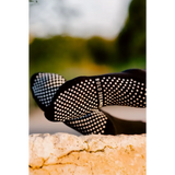 Black grip socks with white dots on a blurred natural background