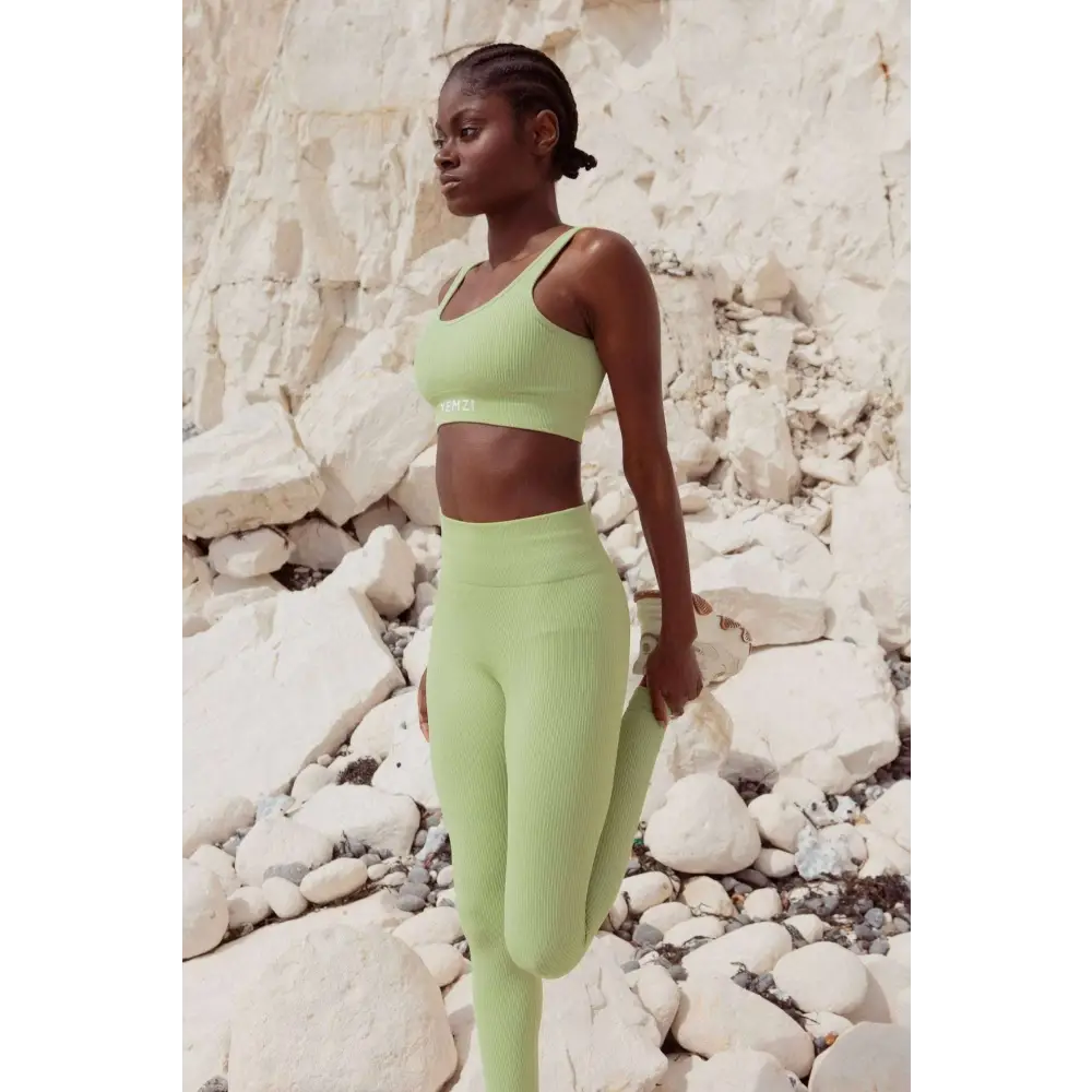 Model wearing Sage Green Sculpt Seamless Ribbed Leggings in front of cliffs 