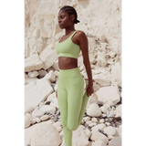 Model wearing Sage Green Sculpt Seamless Ribbed Leggings in front of cliffs 