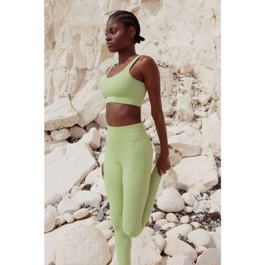 Model wearing Sage Green Sculpt Seamless Ribbed Leggings in front of cliffs 