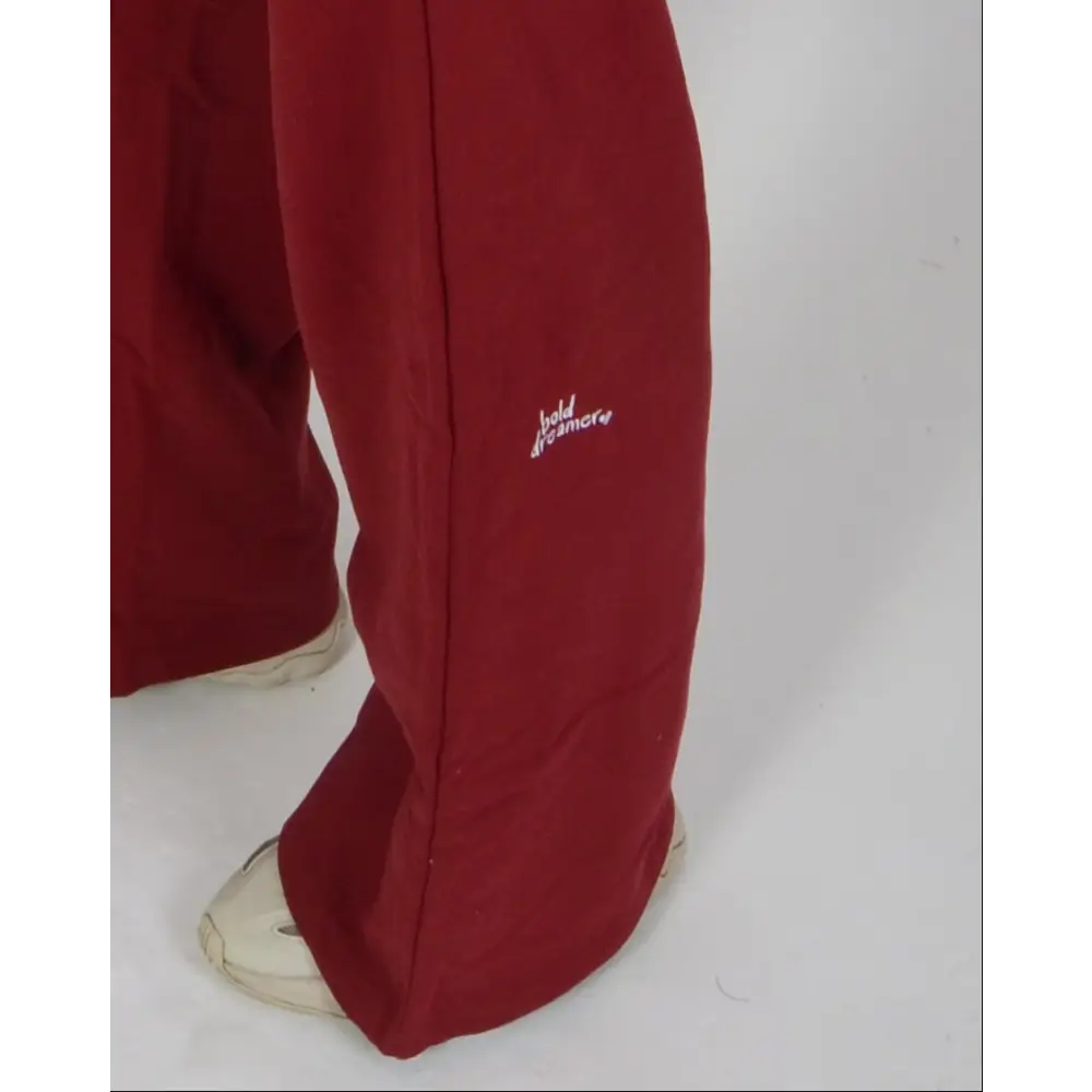 Person wearing a red tracksuit on a white background