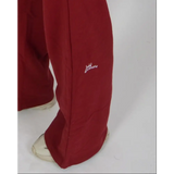 Person wearing a red tracksuit on a white background