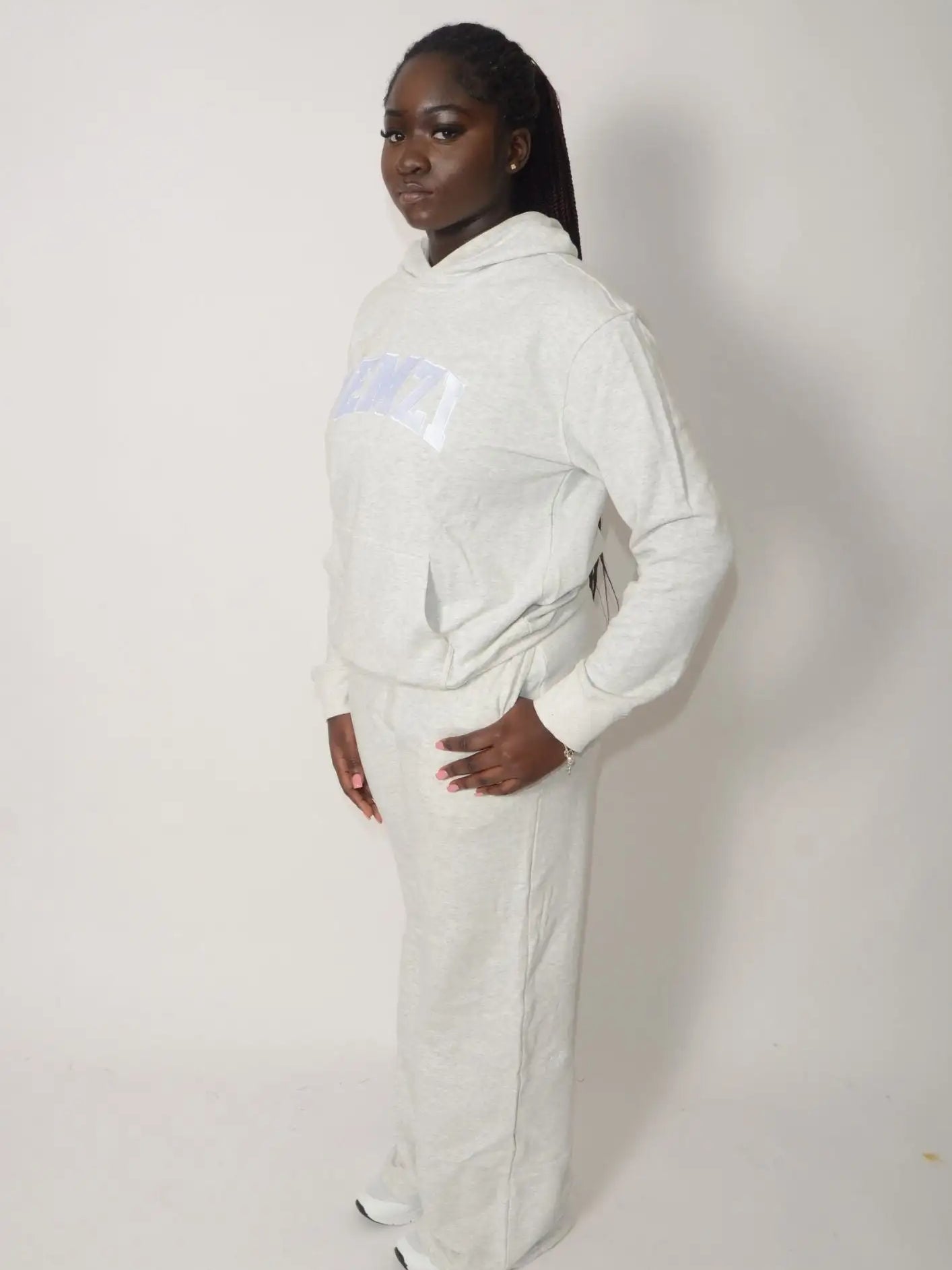White hooded sweatshirt with a subtle translucent rectangular patch on the chest