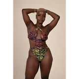 Person wearing a colorful animal print swimsuit on a beige background