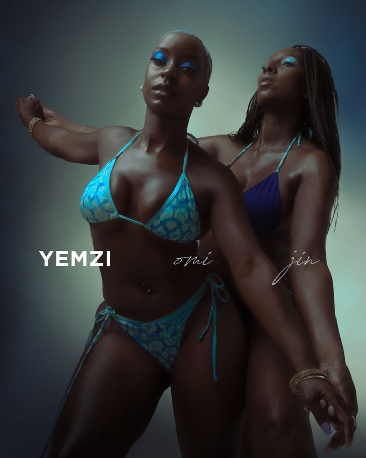 Two women in blue bikinis with 'YEMZI' branding on a gradient background